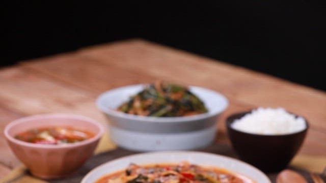 Young radish and saury stew and rice on a wooden table