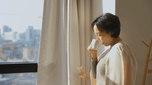 창가에서 커피를 즐기는 여성