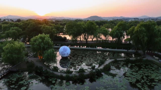 Serene park with a pond at sunset