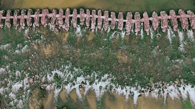 Overhead view of a stone bridge over a river