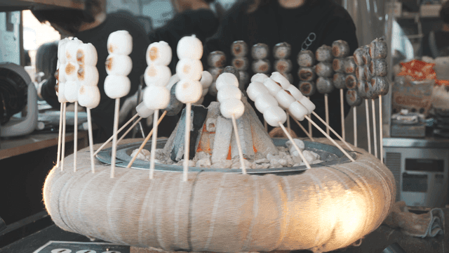 Japanese mochi skewers grilled over charcoal