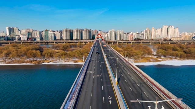 Vehicles on a Bridge over the Han River on a Clear Day