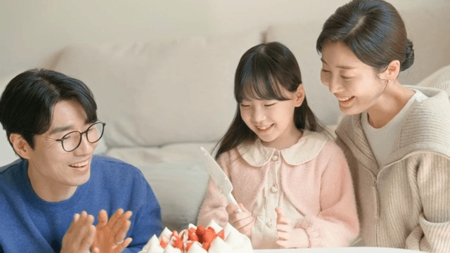 Family celebrating with a cake indoors