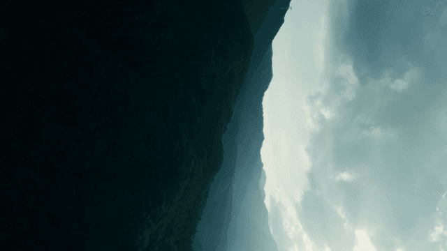 Sunlit mountains with clouds