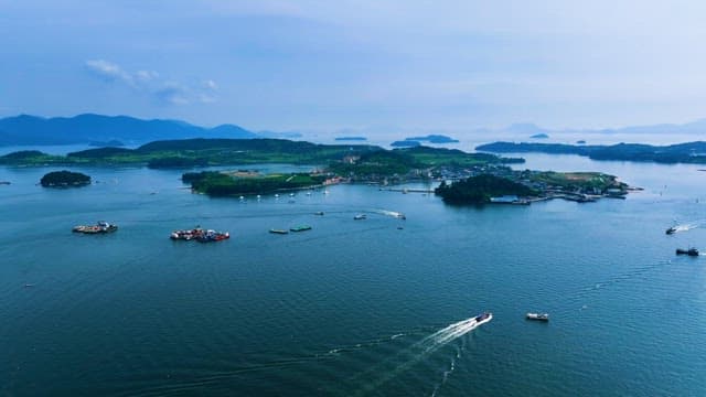 Boats Navigating Coastal Waters Nearby the Islands