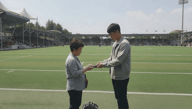 Son, looking depressed, delivers his luggage to his mother at military yard.