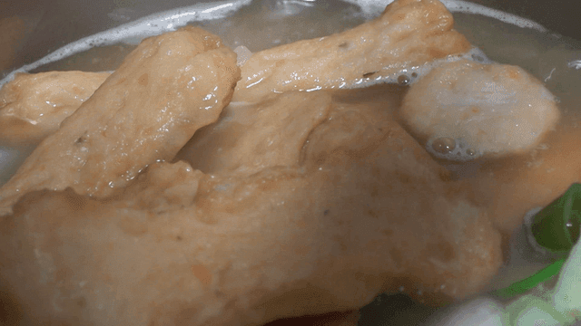 Fish cake soup boiling in a pot