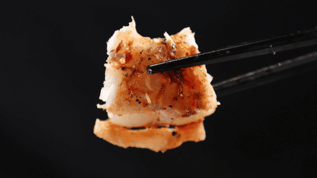 Grilled shrimp picked up with chopsticks
