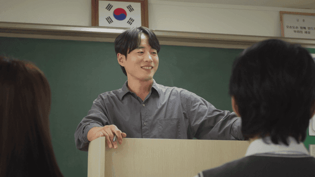 Teacher smiling and communicating with students during class