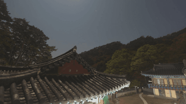 Sky above a temple shifting from night to dawn