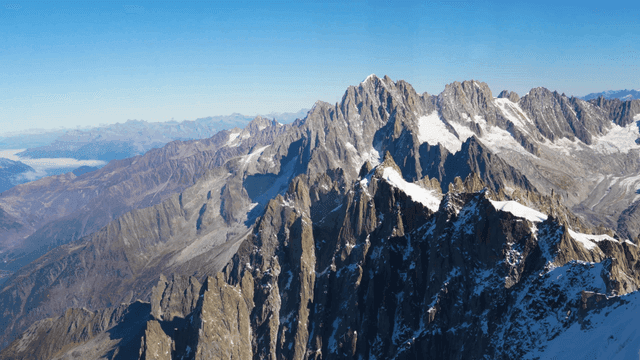 Snow-covered mountain peaks under clear sky