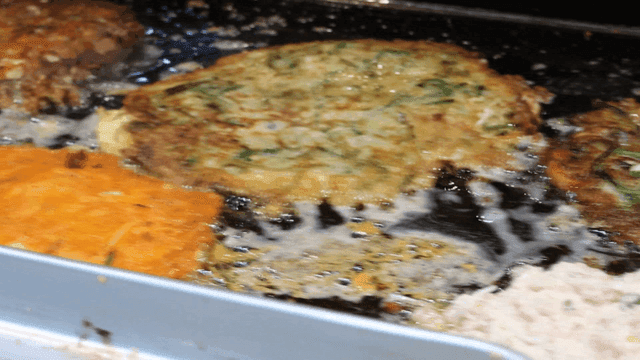 Pancakes frying on a hot griddle