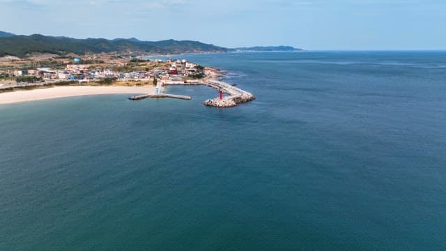 Coastal town with a lighthouse and pier