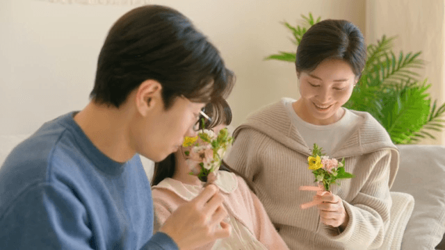 Parents who are happy to receive carnations given by their children