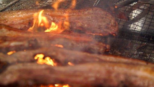 Close-up of Sizzling Pork Belly on a Grill