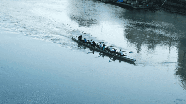 Rowing team practicing on a calm river