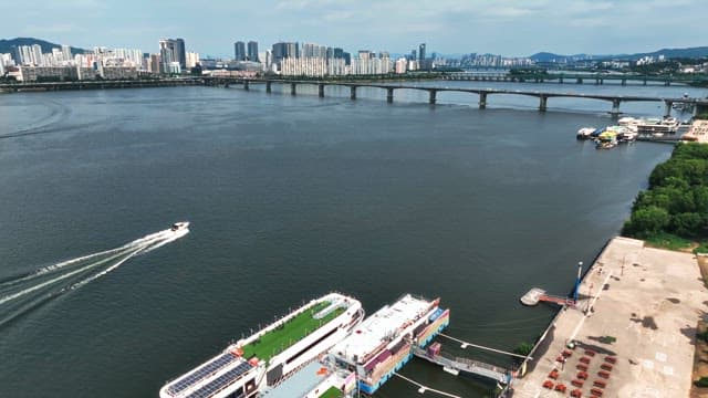 Serene river with a city skyline and boat