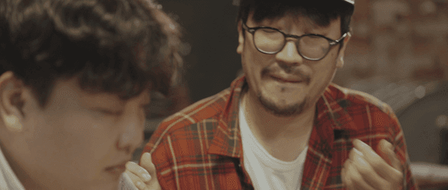 Two drunken men having a serious discussion indoors