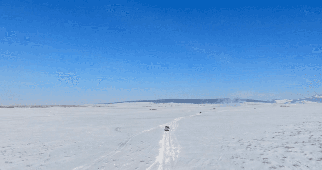 Snowy landscape with a vehicle on a path