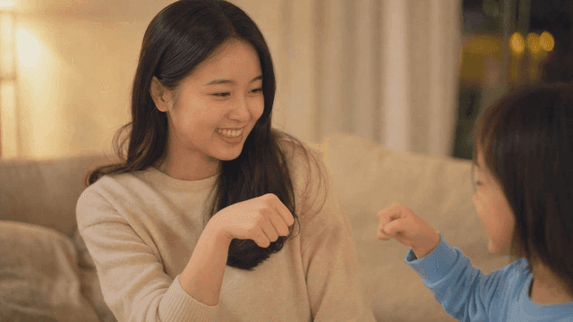 Mother and child exchanging fist bump