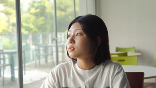 Woman sitting by the window and smiling