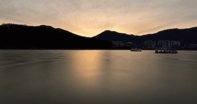 Sunset over a calm lake with mountains
