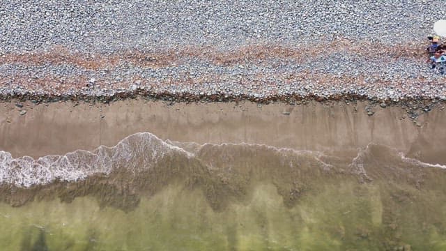 Waves gently hitting a pebble beach