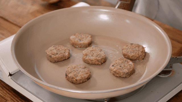 Patties being cooked in a frying pan