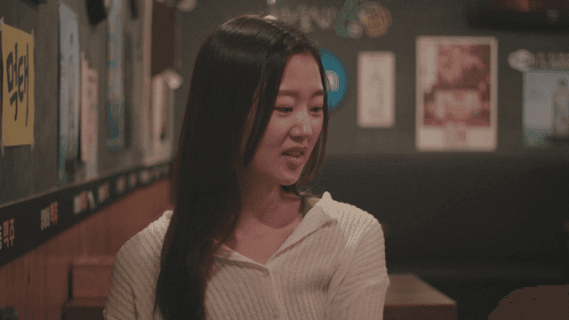 Woman smiling and talking in a cozy pub
