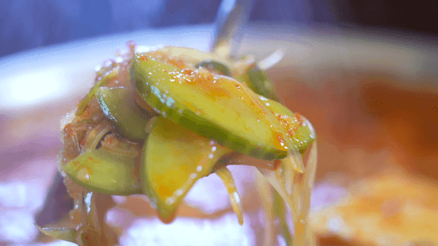 Zucchini Gochujang Stew scooped to brim with ladle