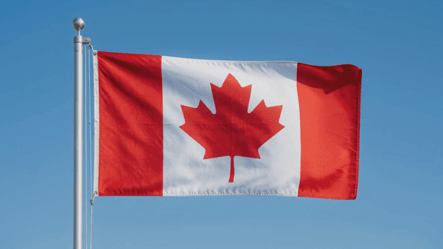 Canadian flag fluttering in wind.