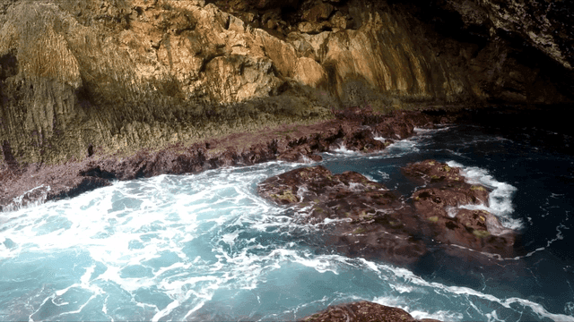 Waves crashing in a rocky sea cave