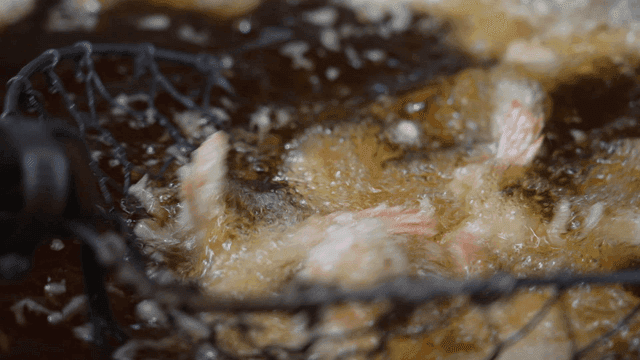 Shrimp being deep-fried in hot oil