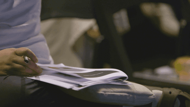 Person reviewing documents with focus