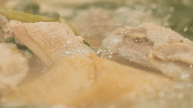 Whole chicken boiling with vegetables