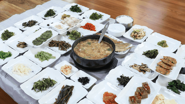 Table with variety of Korean side dishes