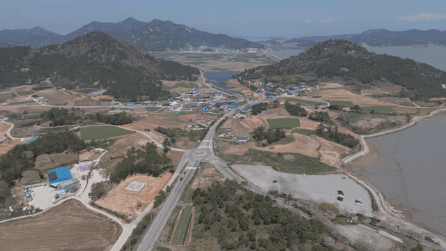 Rural village surrounded by fields and mountains