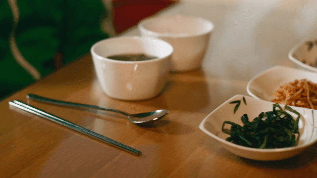 Meal of various side dishes and seaweed soup on table