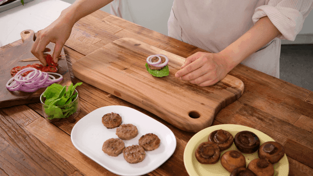Chef making mushroom burgers with fresh ingredients