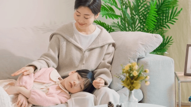Mother gently caressing her sleeping child