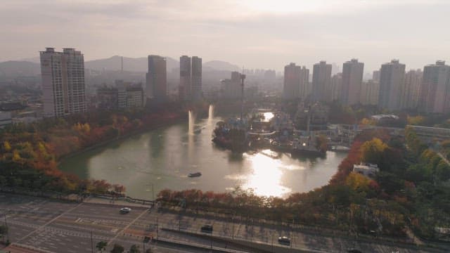 Urban park with autumn trees and high-rises