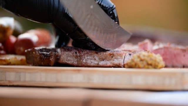 Slicing grilledsteak outdoor