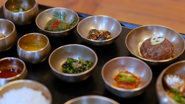 Variety of Korean Traditional Dishes Served in Traditional Metal Bowls