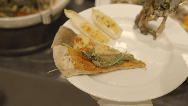 Plate with pizza and salad at a buffet