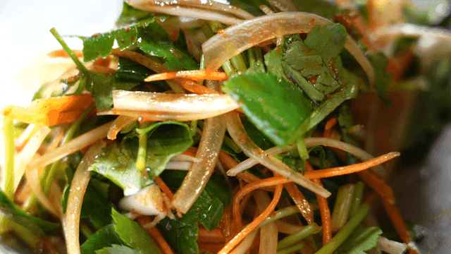 Fresh vegetables being mixed with seasoning