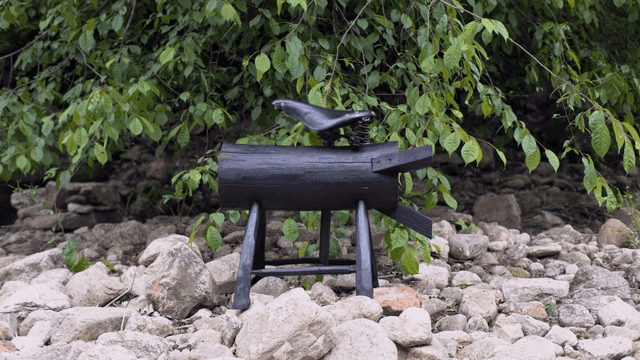Wooden sculpture in a lush green forest