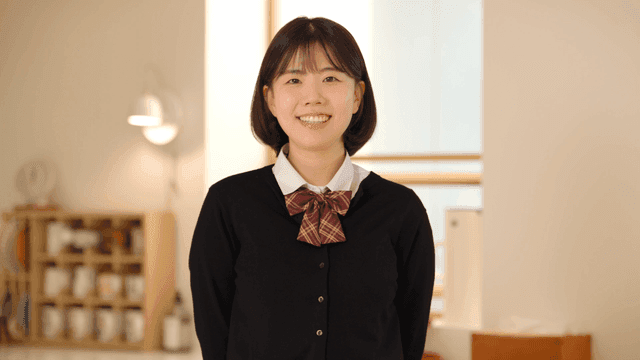 Smiling high school girl at home