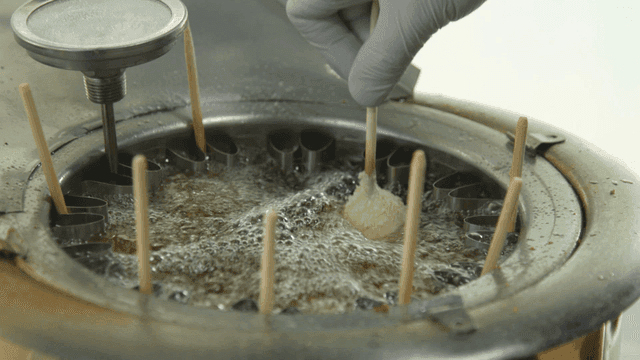 Corn dogs being fried in hot oil