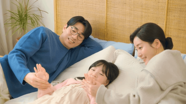 Family spending time together on a bed