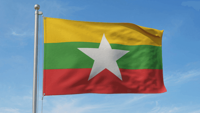 Myanmar flag fluttering under clear sky